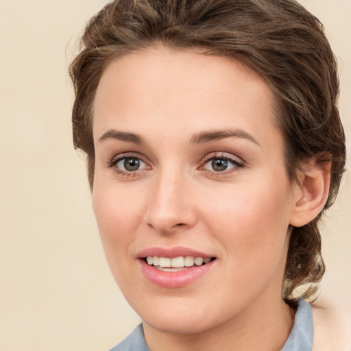 Joyful white young-adult female with medium  brown hair and green eyes