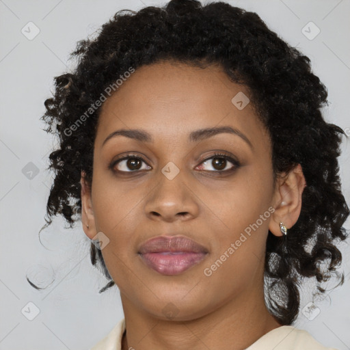 Joyful black young-adult female with long  brown hair and brown eyes