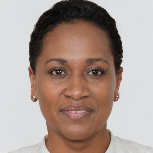 Joyful black adult female with short  brown hair and brown eyes