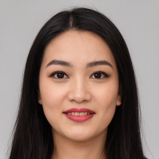 Joyful white young-adult female with long  black hair and brown eyes