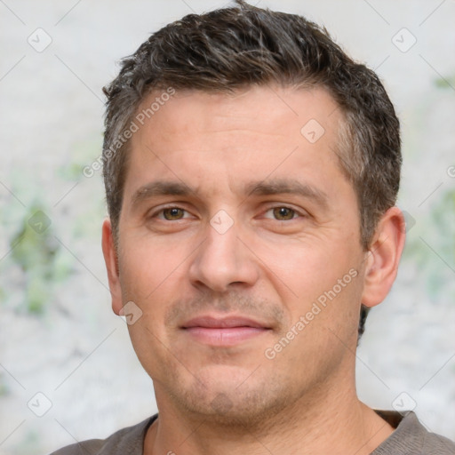 Joyful white adult male with short  brown hair and brown eyes