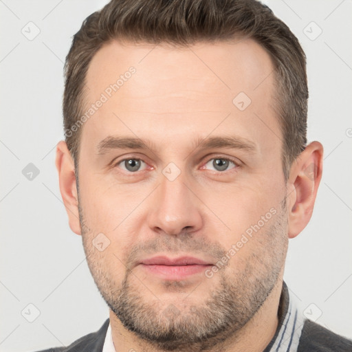 Joyful white adult male with short  brown hair and brown eyes