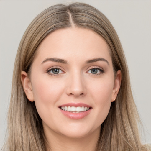 Joyful white young-adult female with long  brown hair and grey eyes