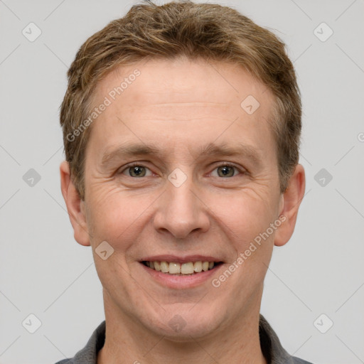 Joyful white adult male with short  brown hair and grey eyes