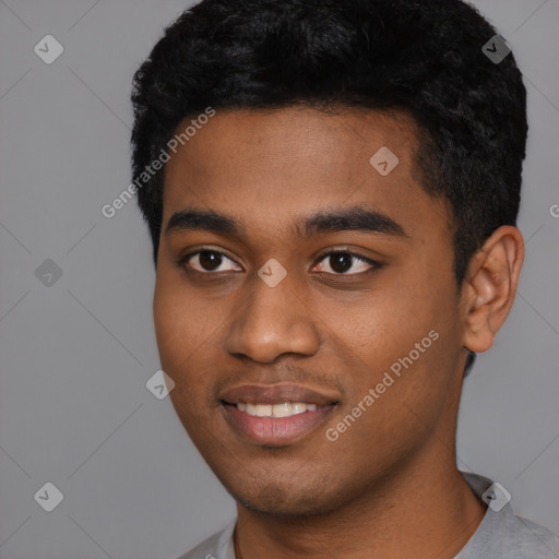 Joyful black young-adult male with short  black hair and brown eyes