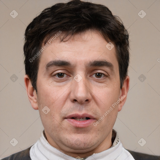 Joyful white adult male with short  black hair and brown eyes