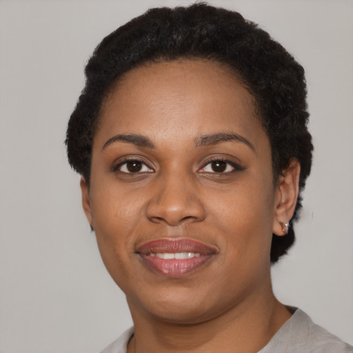 Joyful latino young-adult female with short  black hair and brown eyes