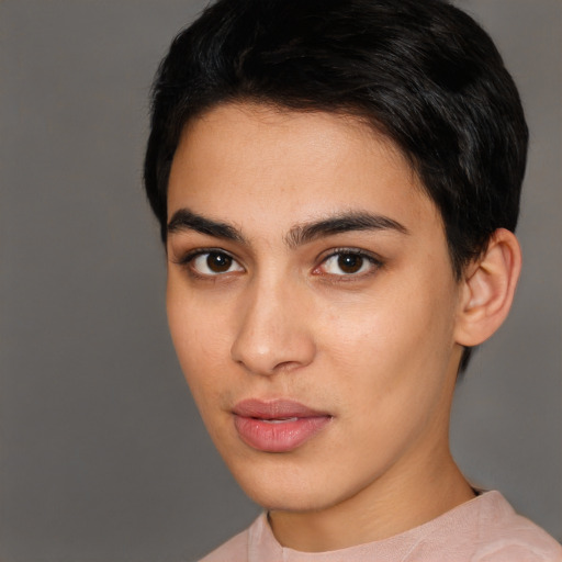 Joyful latino young-adult male with short  brown hair and brown eyes