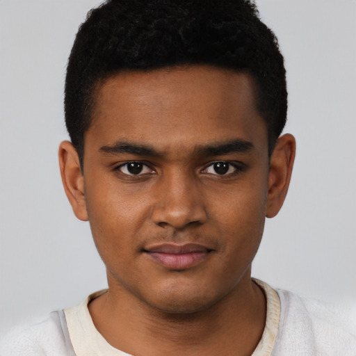 Joyful black young-adult male with short  brown hair and brown eyes
