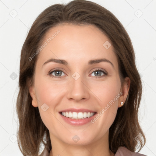 Joyful white young-adult female with long  brown hair and grey eyes