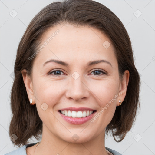 Joyful white young-adult female with medium  brown hair and grey eyes