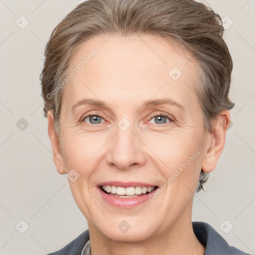 Joyful white adult female with short  brown hair and grey eyes