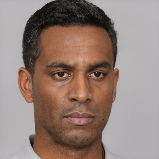 Neutral latino adult male with short  black hair and brown eyes