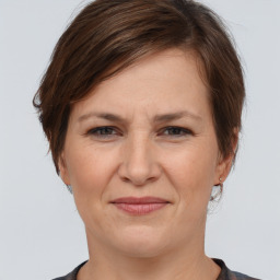 Joyful white adult female with short  brown hair and brown eyes