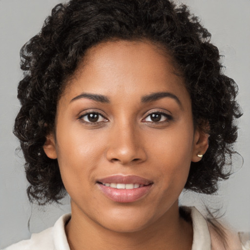 Joyful black young-adult female with medium  brown hair and brown eyes