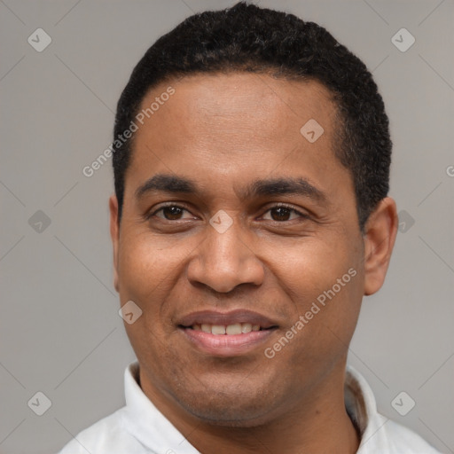 Joyful latino young-adult male with short  black hair and brown eyes