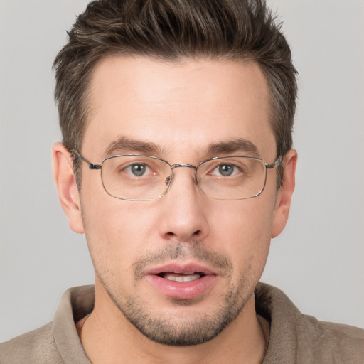 Joyful white adult male with short  brown hair and grey eyes