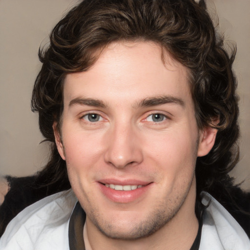 Joyful white young-adult male with medium  brown hair and brown eyes