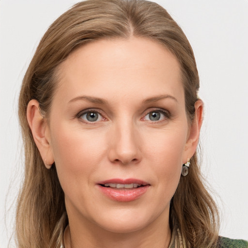 Joyful white young-adult female with medium  brown hair and blue eyes