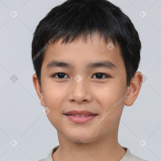 Joyful asian child male with short  brown hair and brown eyes