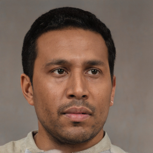 Neutral latino young-adult male with short  black hair and brown eyes