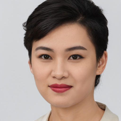 Joyful asian young-adult female with medium  black hair and brown eyes