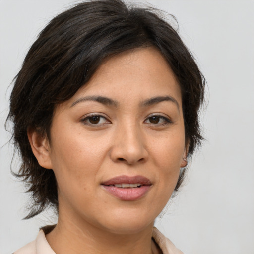Joyful asian adult female with medium  brown hair and brown eyes