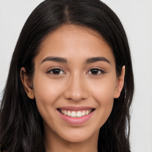 Joyful latino young-adult female with long  brown hair and brown eyes