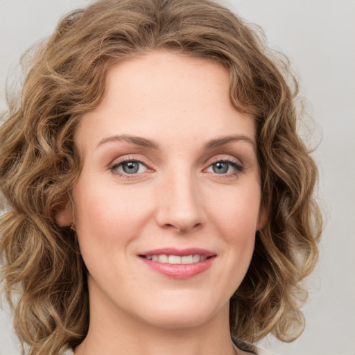 Joyful white young-adult female with medium  brown hair and green eyes