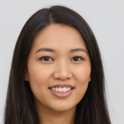 Joyful asian young-adult female with long  brown hair and brown eyes