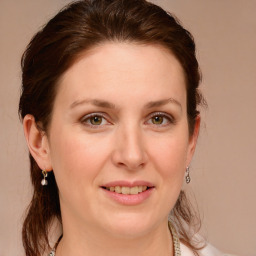 Joyful white young-adult female with medium  brown hair and blue eyes