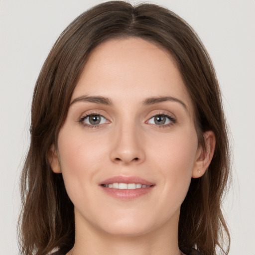 Joyful white young-adult female with long  brown hair and grey eyes