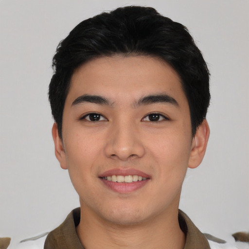 Joyful asian young-adult male with short  black hair and brown eyes