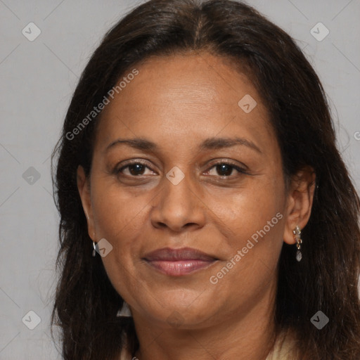 Joyful latino adult female with medium  brown hair and brown eyes