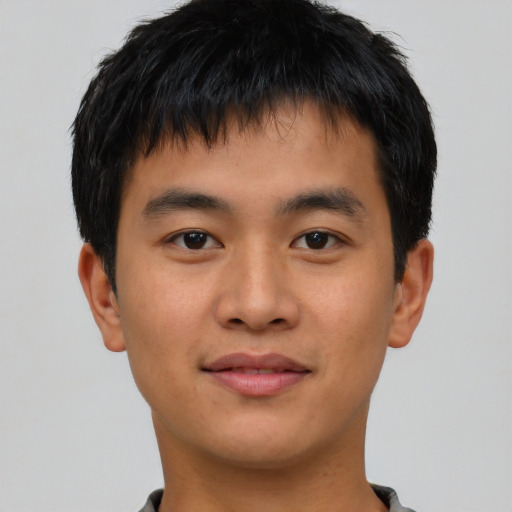 Joyful asian young-adult male with short  black hair and brown eyes