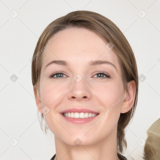 Joyful white young-adult female with medium  brown hair and grey eyes