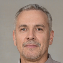 Neutral white middle-aged male with short  gray hair and brown eyes