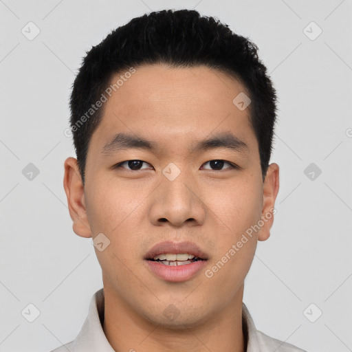 Joyful asian young-adult male with short  black hair and brown eyes