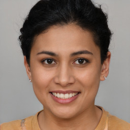 Joyful latino young-adult female with short  brown hair and brown eyes