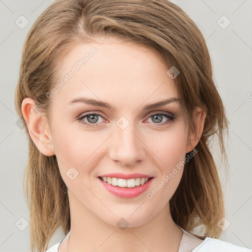 Joyful white young-adult female with medium  brown hair and blue eyes