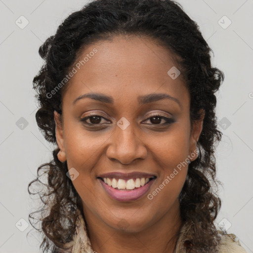 Joyful black young-adult female with long  brown hair and brown eyes