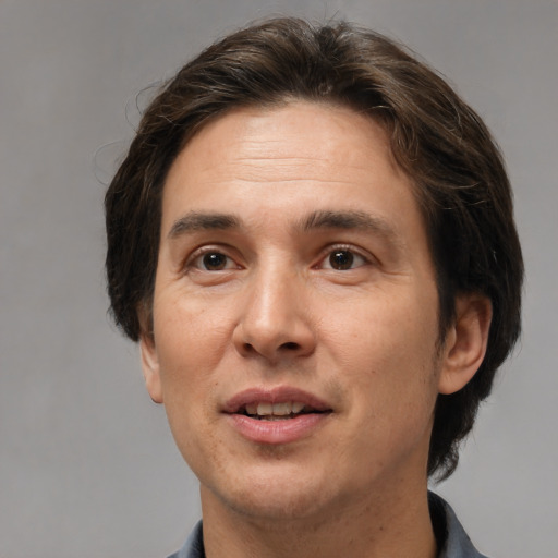 Joyful white adult male with short  brown hair and brown eyes