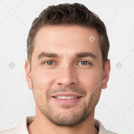 Joyful white young-adult male with short  brown hair and brown eyes