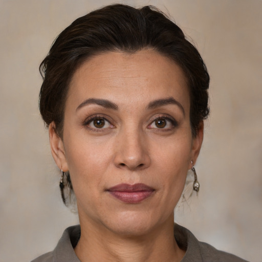 Joyful white adult female with medium  brown hair and brown eyes