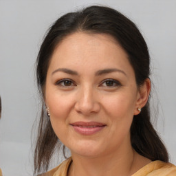 Joyful white adult female with medium  brown hair and brown eyes