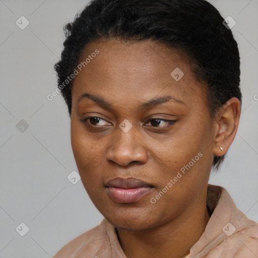 Joyful black young-adult female with short  black hair and brown eyes