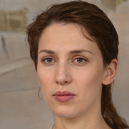 Joyful white young-adult female with medium  brown hair and green eyes