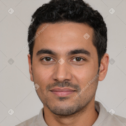 Joyful latino young-adult male with short  black hair and brown eyes