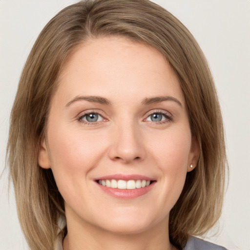 Joyful white young-adult female with medium  brown hair and green eyes