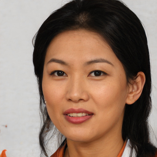 Joyful asian young-adult female with medium  brown hair and brown eyes